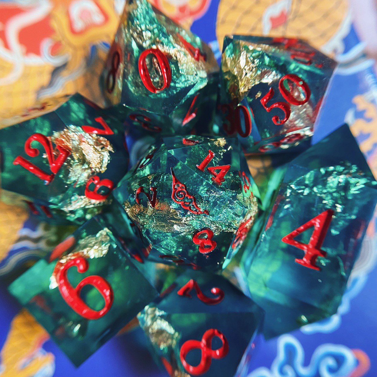 d&d dice set handmade by sambal & mages, inspired by a chinese warrior, green resin with gold foil, inked in red